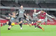  ?? AP ?? Arsenal's Pierre-Emerick Aubameyang scores his side's opening goal against Newcastle United in London on Monday.