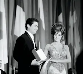  ?? ?? Claude Lelouch films a scene with Jean-louis Trintignan­t for “A Man and a Woman,” top; Lelouch accepts his Palme d’or at the Cannes Film Festival in 1966, bottom.