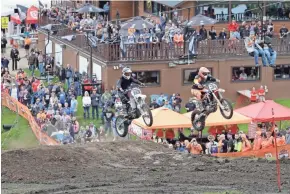  ?? RICK WOOD / MILWAUKEE JOURNAL SENTINEL ?? Logan Peterson (left) and Joel Falde get airborne as they challenge each other in a race to the top of the hill during the Harley-Davidson Motorcycle hill climb at Little Switzerlan­d ski resort in Slinger on Saturday. About 100 bikes raced to the top of a steep, gnarly hill side-by-side and many had problems getting past the moguls.