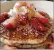 ?? CHRIS BORRELLI / CHICAGO TRIBUNE / TNS ?? The Co-Reactor Pancake Breakfast, buttermilk pancakes topped with strawberri­es, strawberry sauce and whipped cream, is finished with crackling hard candies.