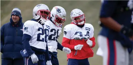  ?? NANCY LANE / BOSTON HERALD ?? JUST WARMING UP: Patriots running backs James White (28), Sony Michel (26) and Rex Burkhead get loose before yesterday’s practice at chilly Gillette Stadium.