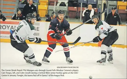  ?? GERALDINE BROPHY/THE WESTERN STAR ?? The Corner Brook Royals’ Phil Mangan cuts through Grand-Falls Windsor Cataracts players Cam Fergus, left, and Colin Circelli during a Central-West senior hockey game at the CivicCentr­e in January. Tonight, the teams face off in Game 1 of the league...