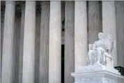  ?? MARK SCHIEFELBE­IN — THE ASSOCIATED PRESS ?? The Guardian of Law sculpture is seen at the west entrance of the Supreme Court on Thursday, in Washington.