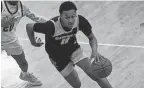  ?? BROOKE LAVALLEY/COLUMBUS DISPATCH ?? ESPN lists Garfield Heights guard Marcus Johnson (11) as a five-star prospect and the No. 12 overall player in the 2026 recruiting class.
