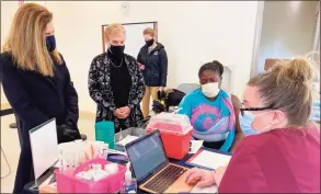  ?? Donald Eng / Hearst Connecticu­t Media ?? State Police Trooper Tamia Tucker prepares to receive Moderna’s COVID-19 vaccine from Trumbull Public Health Nurse Samantha Cousins on Tuesday at the Center at Priscilla Place. Lt. Gov. Susan Bysiewicz is at left.