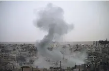  ??  ?? Smoke rises from buildings in a rebel-held neighbourh­ood of Deraa after shelling by the regime on May 22