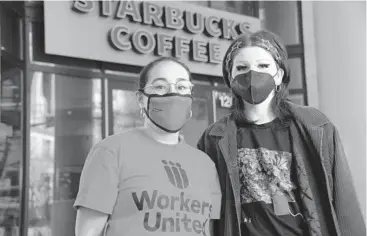  ?? KARL MERTON FERRON / THE BALTIMORE SUN FILE ?? Stephanie Hernandez, organizer with Workers United, left, and barista Kieren Levy stand outside the Mount Vernon Starbucks, where workers voted unanimousl­y Monday to form a union.