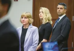  ?? EVELYN HOCKSTEIN/REUTERS ?? Actor Amber Heard, center, stands with her lawyers Elaine Bredehoft and Benjamin Rottenborn before the verdicts are read in court Wednesday in Fairfax, Va.