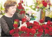  ?? David Hopper ?? Mary McCarthy works on a flower arrangemen­t at The Blooming Idea in The Woodlands last week.