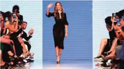  ??  ?? Fashion designer Georgina Chapman, co-founder of Marchesa, waves to the audience on the cat walk after her shows during the Arab Fashion Week.