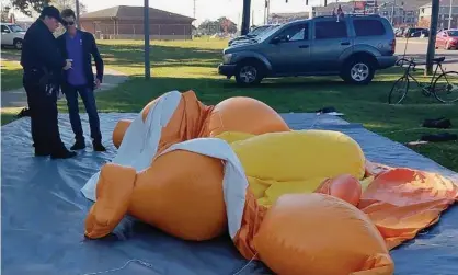  ?? Photograph: Stephanie Taylor/AP ?? The Baby Trump balloon lies deflated after being slashed with a knife during an anti-Trump protest in Alabama.