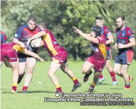  ??  ?? ● Caernarfon attempt to stop Llangefni’s Huw Campbell in his tracks