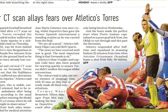  ?? REUTERS PIC ?? MONDAY: Referee Carlos Clos Gomez calls for medical assistance as Atletico Madrid’s Fernando Torres lies injured on the ground during their match against Deportivo La Coruna .