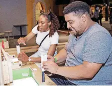  ??  ?? Two museum guests build paper rockets during SMO 21 in June at Science Museum Oklahoma’s adults-only night.