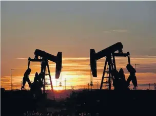  ?? NICK OXFORD/REUTERS ?? Pump jacks operate at sunset in an oil field in Midland, Texas, last year.