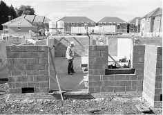  ??  ?? Workers construct residentia­l homes at a building site in north London. — Reuters photo