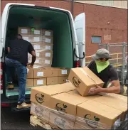  ?? PHOTO COURTESY PAULA SCHAFER ?? MontCo Anti-Hunger Network Food Resource Driver, Ron Levine, left, and Lansdale Warehouse Company Maintenanc­e Assistant, Steve Wheeler, right, load USDA produce boxes for delivery to area food pantries into MAHN’s van.