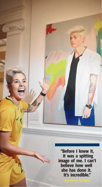 ?? Picture: ALISON WYND ?? SPITTING IMAGE: Australian soccer player Michelle Heyman admires her Archibald Prize portrait at Geelong Gallery yesterday.
