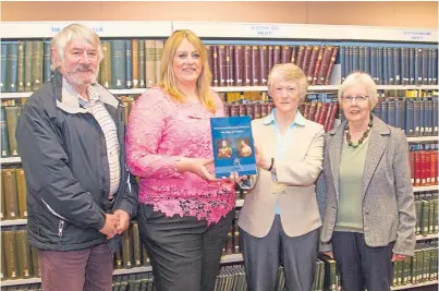  ?? Picture: Paul Reid. ?? Facilities officer Claire Tracey, second left, receives the book on botanist William Paterson from Forfar and District Historical Society members David Orr, Alice Bremner, second right, and Aileen Elliott.