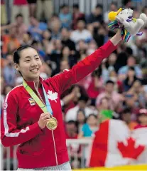  ?? DARREN CALABRESE/The Canadian Press ?? Michelle Li of Canada poses with the gold medal she won in
women’s singles badminton at the 2015 Pan Am Games.