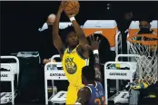  ?? RICK SCUTERI — THE ASSOCIATED PRESS FILE ?? Golden State Warriors center James Wiseman (33) shoots over Phoenix Suns center Deandre Ayton during the first half Thursday, March 4, in Phoenix.