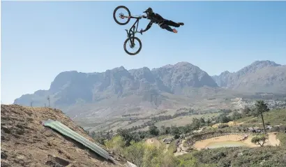  ?? Picture: EPA ?? A rider competes in the DarkFest freeride mountain biking event in Stellenbos­ch on Saturday. DarkFest is part of the global Fest series of extreme freeride mountain biking.