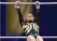  ?? The Associated Press ?? ■ LSU gymnast Olivia Dunne competes during a gymnastics meet against Arkansas on Jan. 8, 2021, in Baton Rouge, La.