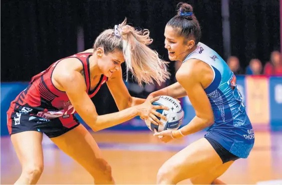  ?? Photo / Photosport ?? Jane Watson of the Tactix (left) and Mystics player Tayla Earl scrap for the ball.