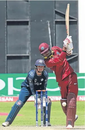  ?? Picture: AP. ?? Marlon Samuels plays a shot as Scotland wicketkeep­er Mathew Cross looks on. The Scots came agonisingl­y close to World Cup qualificat­ion before rain ended their chances.