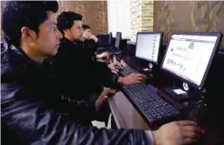  ??  ?? KABUL: An Afghan university student looks at a ‘Be Like Bill’ Internet meme on a Facebook account at Kardan university in Kabul yesterday. The text reads “This is Qodos and Qodos does not pay or receive bribe, he respects the law. Qodos is smart. Be...