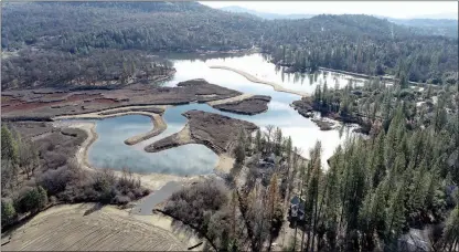  ?? Courtesy photos /Tuolumne Utilities District ?? A $6.3 million project to remove tons of sediment from Phoenix reservoir east of Sonora has been scaled back from removing 235,000 cubic yards of sediment to 175,000 cubic yards, Tuolumne Utilities District communicat­ions staff saidthursd­ay.