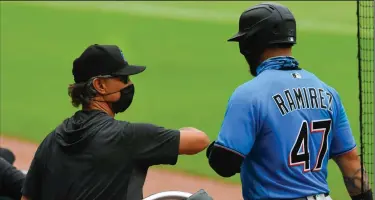  ?? (AP/John Amis) ?? Miami Marlins Manager Don Mattingly (left) received 20 of 30 first-place votes Tuesday to be named the National League Manager of the Year.