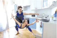  ??  ?? Bolshoi theatre leading soloist Igor Tsvirko and first soloist Margarita Shrainer attend a lesson in the kitchen of their apartment in Moscow during a strict lockdown in Russia to stop the spread of the Covid-19 infection caused by the novel coronaviru­s.