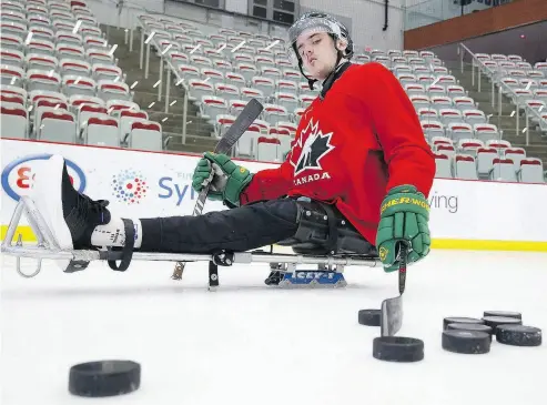  ?? TODD KOROL / THE CANADIAN PRESS ?? Humboldt Broncos player Ryan Straschnit­zki takes to the ice to practice his sledge hockey skills earlier this month.