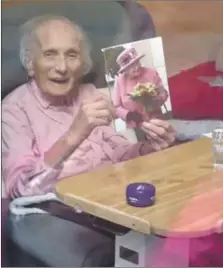  ??  ?? Socially isolated, but this remarkable lady was still smiling on her 106th birthday in Glasgow last week as she opened her card from the Queen.