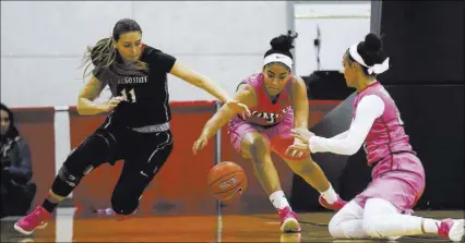  ?? CHASE STEVENS/LAS VEGAS REVIEW-JOURNAL @CSSTEVENSP­HOTO ?? UNLV sophomore forward Paris Strawther, center, scrambles after a loose ball against junior teammate Dakota Gonzalez and San Diego State forward Arantxa Gomez on Saturday at Cox Pavilion. Strawther scored a career-high 18 points in the Lady Rebels’...