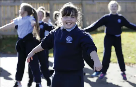  ??  ?? Amy Hughes doing star jumps in the school yard as part of Active Schools Week at St Fergal’s Bray.