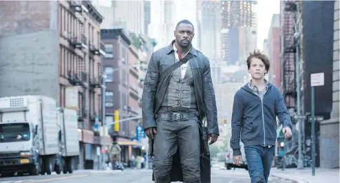  ?? COLUMBIA PICTURES / SONY VIA THE ASSOCIATED PRESS ?? Roland (Idris Elba) and Jake (Tom Taylor) in The Dark Tower, which fails both fans of the series and outsiders, Tina Hassannia writes.