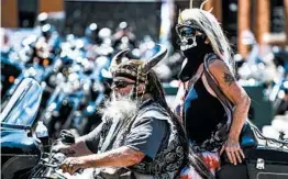  ?? MICHAEL CIAGLO/GETTY ?? Motorcycli­sts ride down a street Friday during the Sturgis Motorcycle Rally in South Dakota.