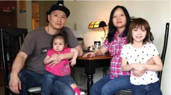  ?? GOSIA WOZNIACKA/THE ASSOCIATED PRESS FILE PHOTO ?? Adam Crapser, with daughters Christal, 1, Christina, 5, and his wife, Anh Nguyen, has had a tough life in the U.S.