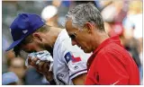 ?? RICHARD W. RODRIGUEZ / AP ?? Texas’ Joey Gallo is escorted off by trainer Kevin Harmon after a collision with pitcher Matt Bush in the eighth inning Sunday.