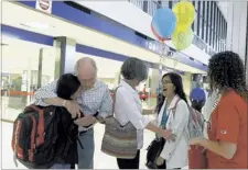  ??  ?? Jim Boyd (left), his wife, Martha, and Rhodes student Angela Izmirian were on hand to pick up Lisa Hun and Bormey Sivorn them when they arrived at Memphis Internatio­nal Airport. Lina hugs Jim, and Martha greets Bormey.