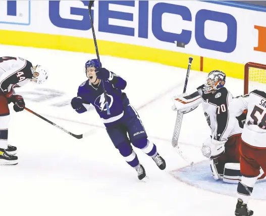  ?? GETTY IMAGES ?? Tampa Bay’s Ondrej Palat, centre, celebrates the game-winning goal by Brayden Point (not shown) against the Columbus Blue Jackets at 10:27 of the fifth overtime period in Game 1 of their Eastern Conference first-round playoff series in Toronto on Tuesday. The Lightning won 3-2 in the fourth-longest game in NHL history.