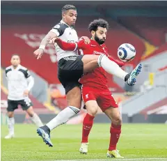  ?? AFP ?? Fulham’s Mario Lemina, left, beats Liverpool’s Mohamed Salah in the build-up to his match-winning goal against the Reds at Anfield.