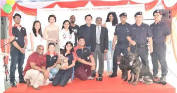  ??  ?? The AniHELP team with the K9 unit of the Royal Malaysia Police which trains service dogs.