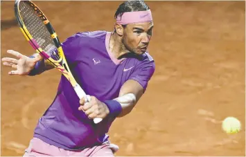  ?? FILIPPO MONTEFORTE/AFP VIA GETTY IMAGES ?? Spain's Rafael Nadal returns a backhand to Italy's Jannik Sinner during their match at the Men's Italian Open at Foro Italico Tuesday in Rome.