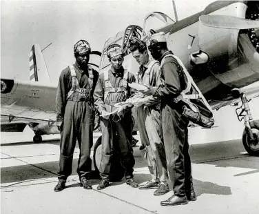  ?? ASSOCIATED PRESS ?? A White Army instructor looks over a map with Black cadets in Tuskegee, Ala., before a cross-country flight in 1942.