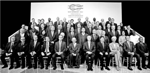  ??  ?? G-20 finance ministers and central bank governors pose for a family photo before a plenary session during the IMF/World Bank annual meetings in Washington, US, October 12. Finance chiefs from around the world were warned to get their houses in order...