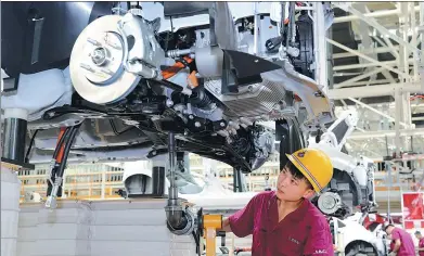  ?? JIANG SHENG / FOR CHINA DAILY ?? A worker fastens a screw at a production line in a JAC Motors plant in Anqing, Anhui province.