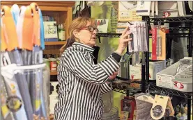  ?? / Ross Rogers ?? Riverside Gourmet store manager Nancy Brass works on inventory on Wednesday afternoon. “We are excited about the new owners,” Brass said. “It’ll be a lot of fun. They are planning on having beef, pork and lamb from their farm in Cave Spring as well as cheese from a local producer.”